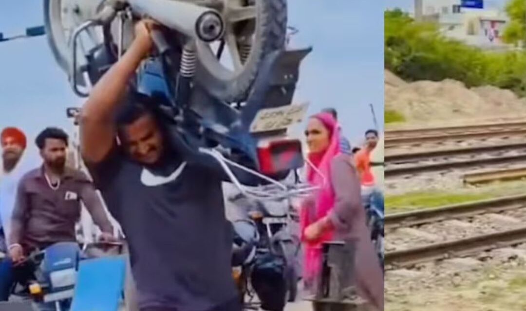 Trending: To avoid waiting at a railway crossing, a man lifts a 112 kg bike on his shoulders