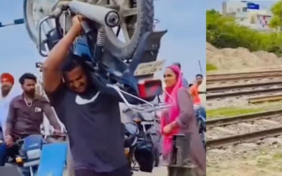 Trending: To avoid waiting at a railway crossing, a man lifts a 112 kg bike on his shoulders