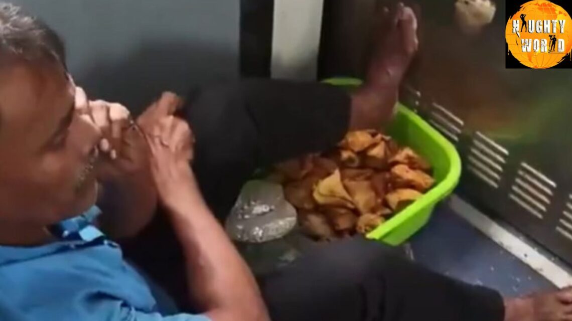 Trending: A vendor in a moving train rests his feet on a basket of samosas