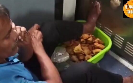 Trending: A vendor in a moving train rests his feet on a basket of samosas